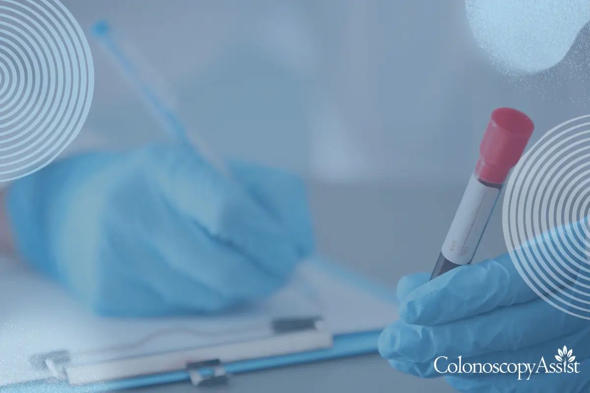 A person in blue gloves holds a test tube with a red cap, possibly conducting research related to colorectal cancer, while meticulously writing on a clipboard.