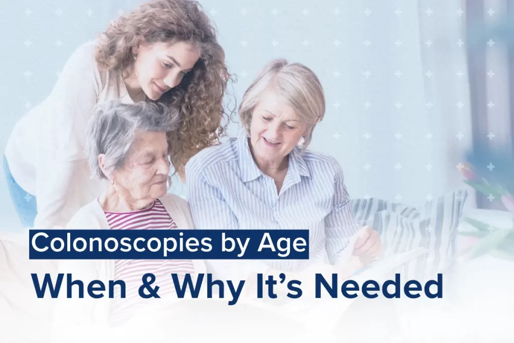 Three women from different generations sit together. The oldest woman, seated, is accompanied by a middle-aged woman and a younger woman leaning over her shoulder, reviewing over colonoscopy age guidelines.