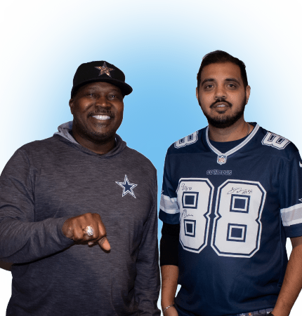 Two men dressed in sports apparel, one pointing with a ring-adorned finger, stand against a blue background—discussing the importance of accessibility and affordability for health services like low-cost colonoscopies.